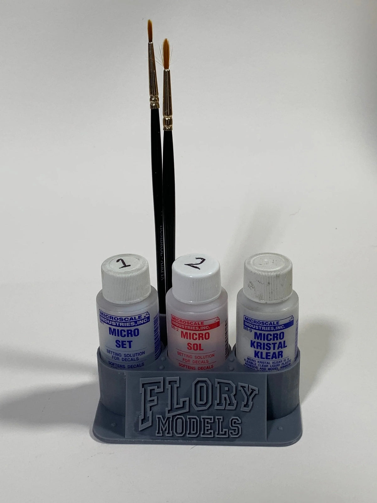 Flory Models 3D Printer Micro 3 Pot Holder holding three Micro Set and Micro Sol sized bottles on a scale modelling workbench.